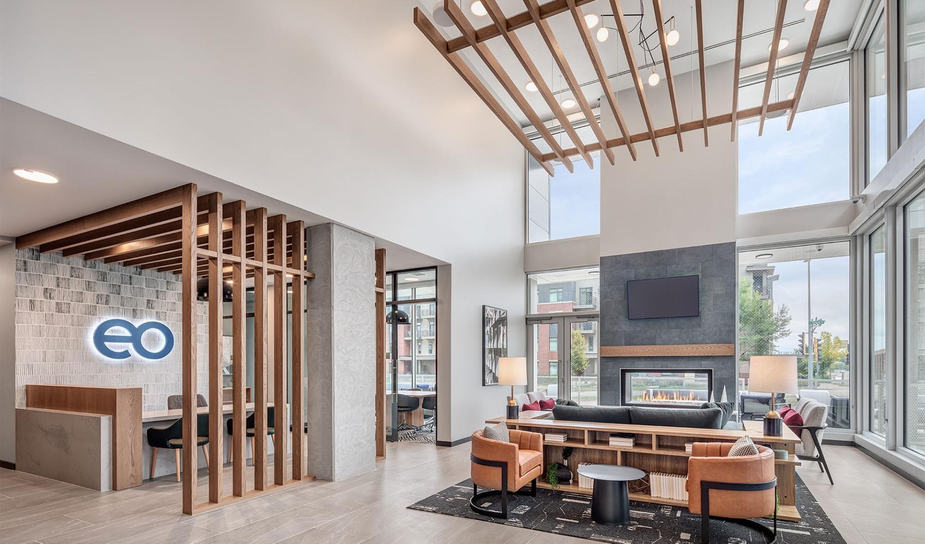 a room with a wood floor fireplace seating and a tv