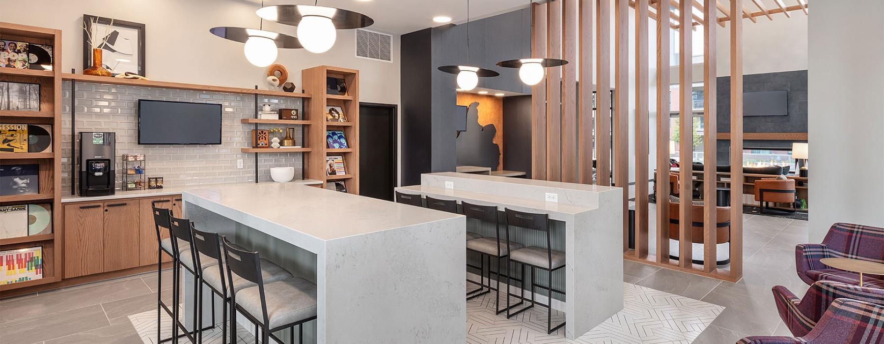 a community kitchen and dining room with seating tables and tv