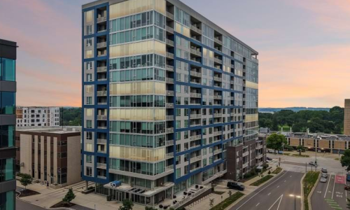 EO Madison Yards luxury apartment building exterior at dusk in Madison WI