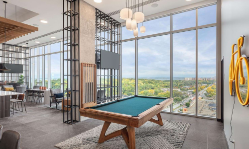 Rooftop game room with pool table and floor-to-ceiling windows overlooking Madison lake views