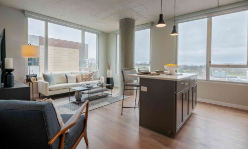 Open-concept two-bedroom kitchen and living room with floor-to-ceiling windows