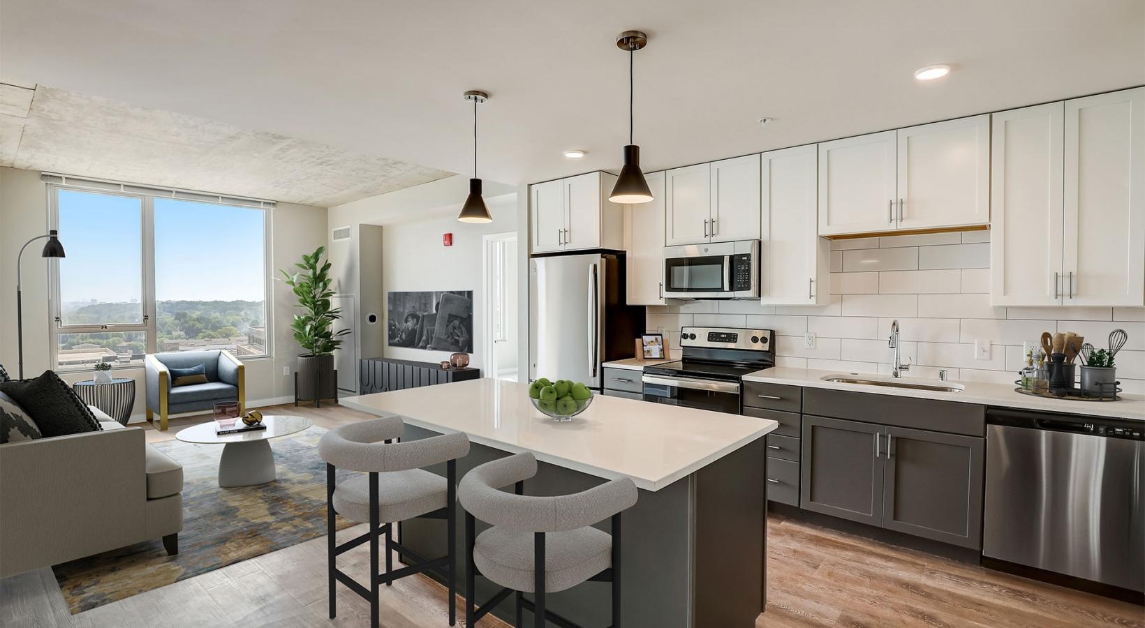 a kitchen with a bar and chairs